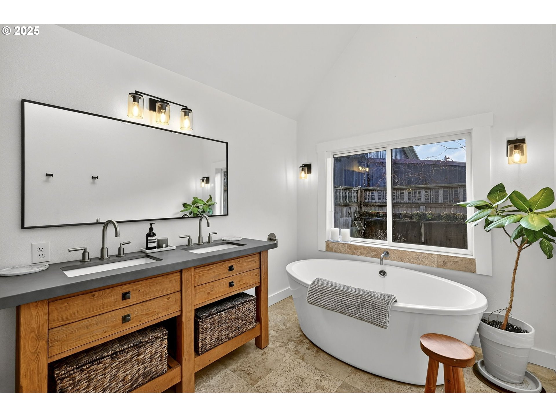 13162 Northwest McNamee Road Portland, OR 97231 - Photo 25 of 48 a spacious bathroom with a double vanity sink a mirror a bathtub and next to a window