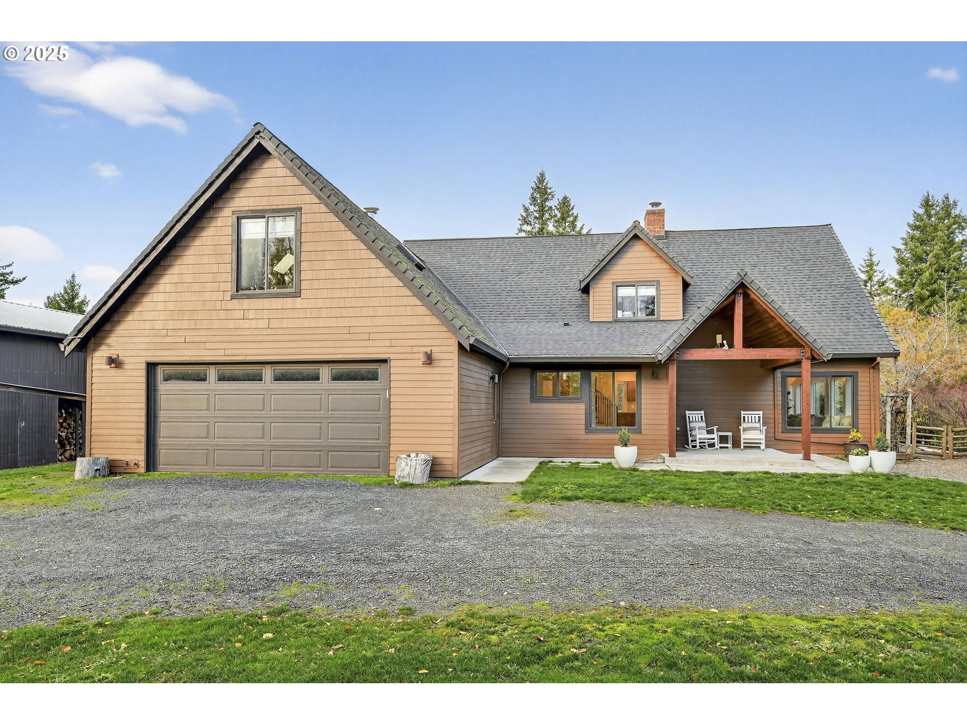 13162 Northwest McNamee Road Portland, OR 97231 - Photo 5 of 48 a front view of a house with a yard and garage