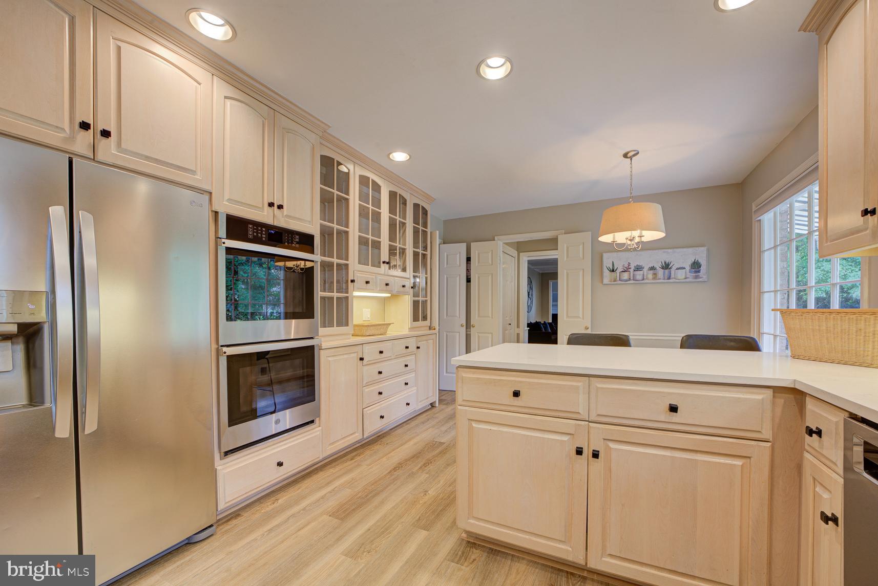 9116 Wooden Bridge Road Potomac, MD 20854 - Photo 11 of 22 a kitchen with stainless steel appliances cabinets and wooden floor
