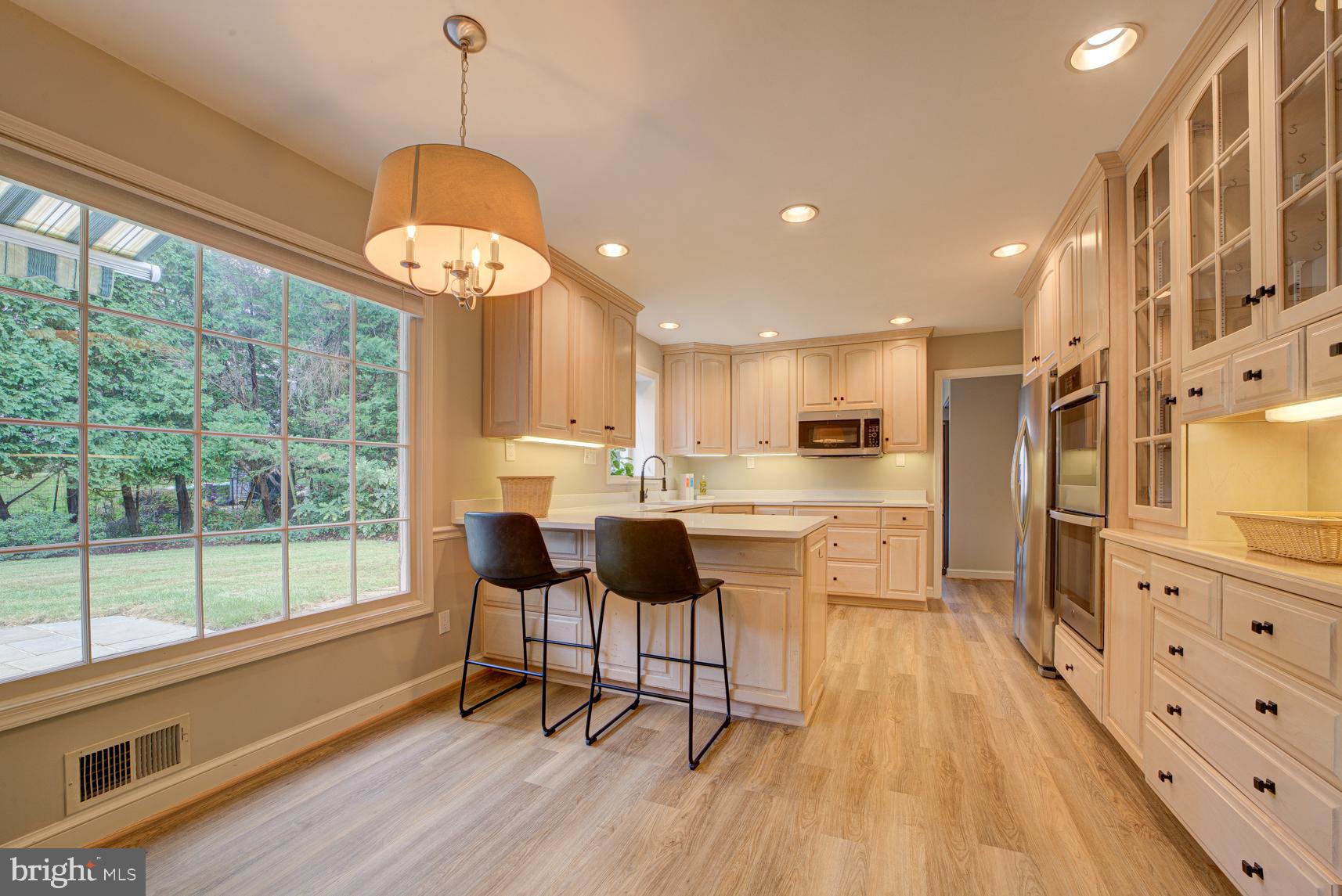 9116 Wooden Bridge Road Potomac, MD 20854 - Photo 12 of 22 a kitchen with stainless steel appliances granite countertop a stove and refrigerator