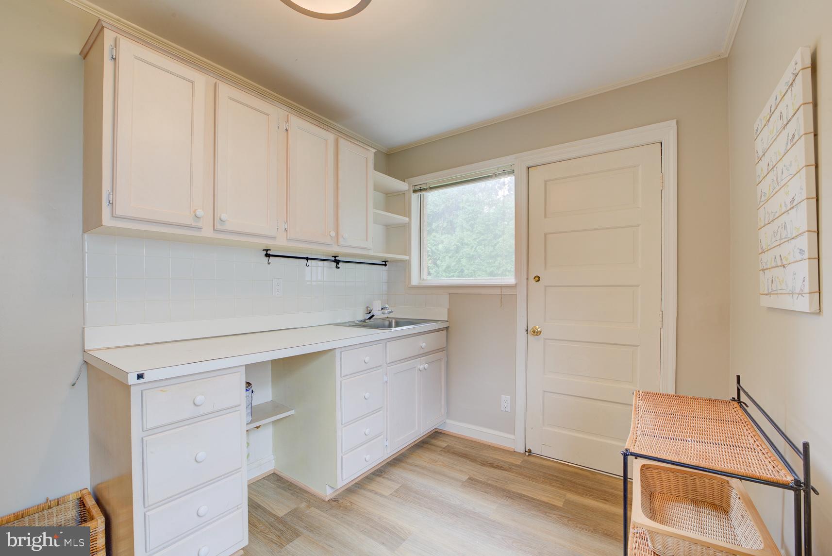 9116 Wooden Bridge Road Potomac, MD 20854 - Photo 14 of 22 a room with a sink cabinets and a window