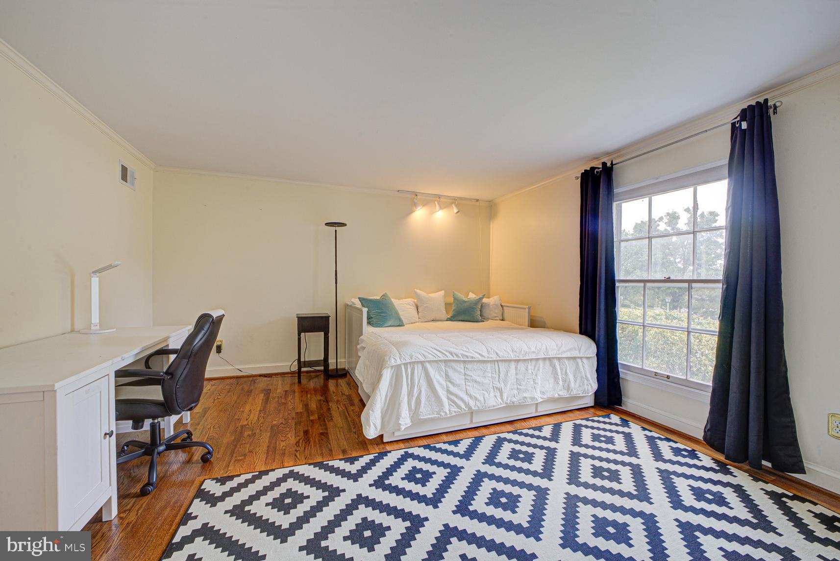 9116 Wooden Bridge Road Potomac, MD 20854 - Photo 17 of 22 a bedroom with a bed and wooden floor