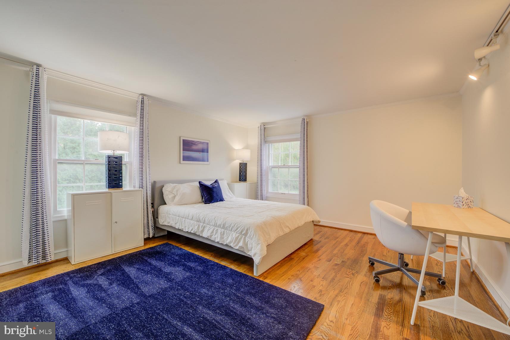 9116 Wooden Bridge Road Potomac, MD 20854 - Photo 19 of 22 a bedroom with a bed and wooden floor