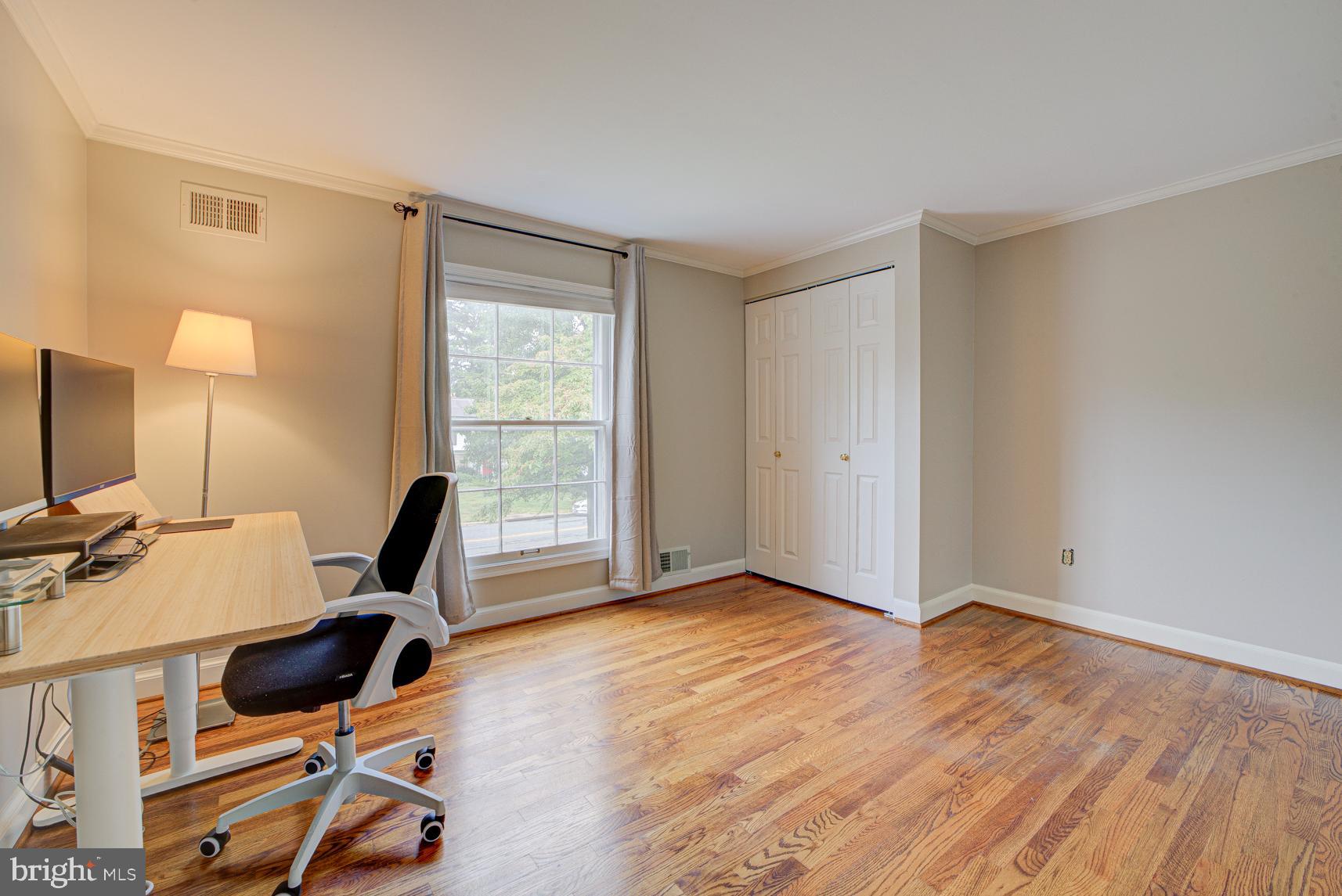 9116 Wooden Bridge Road Potomac, MD 20854 - Photo 20 of 22 a view of a workspace with furniture and a window