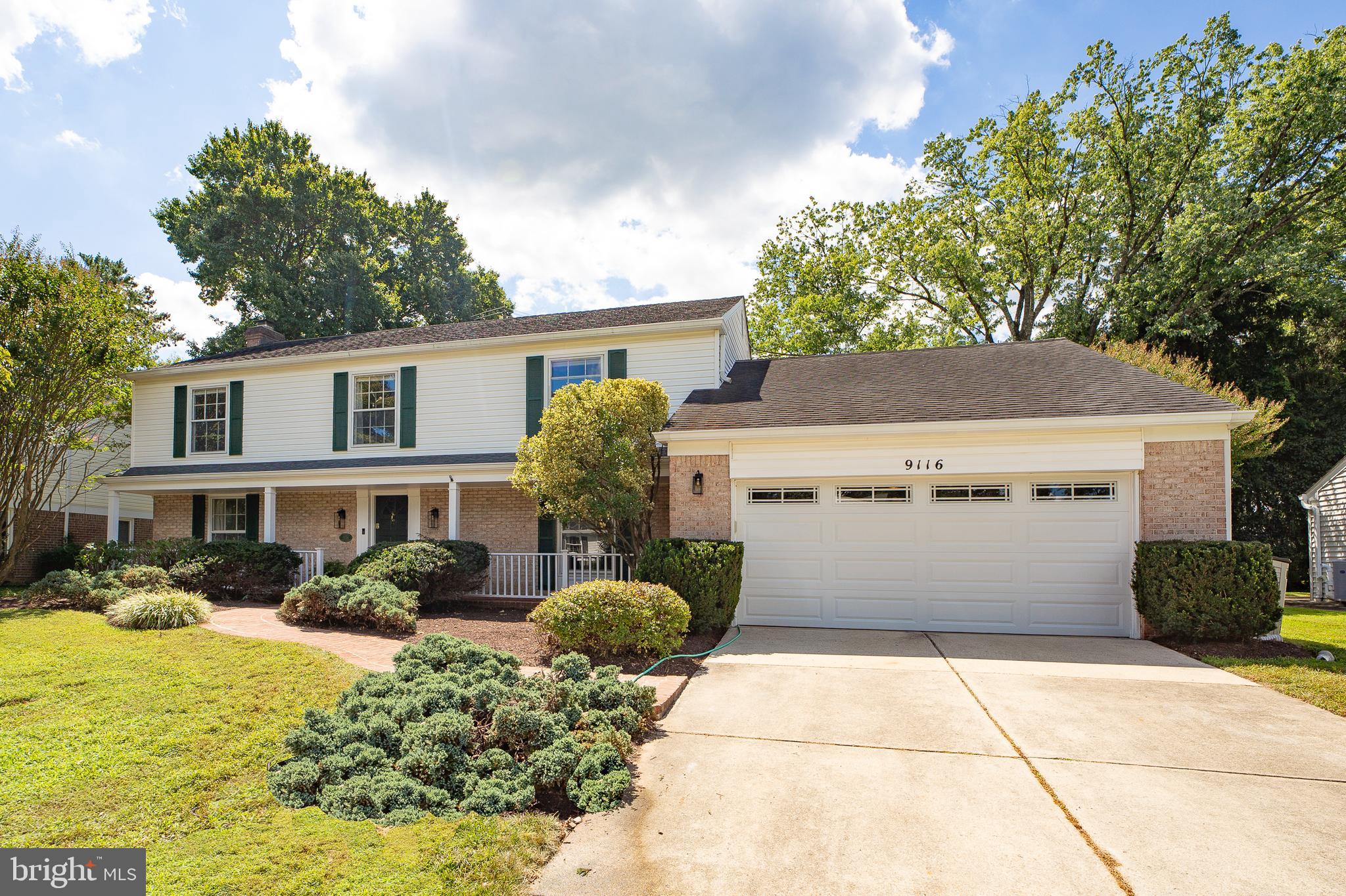 9116 Wooden Bridge Road Potomac, MD 20854 - Photo 2 of 22 a front view of a house with garden