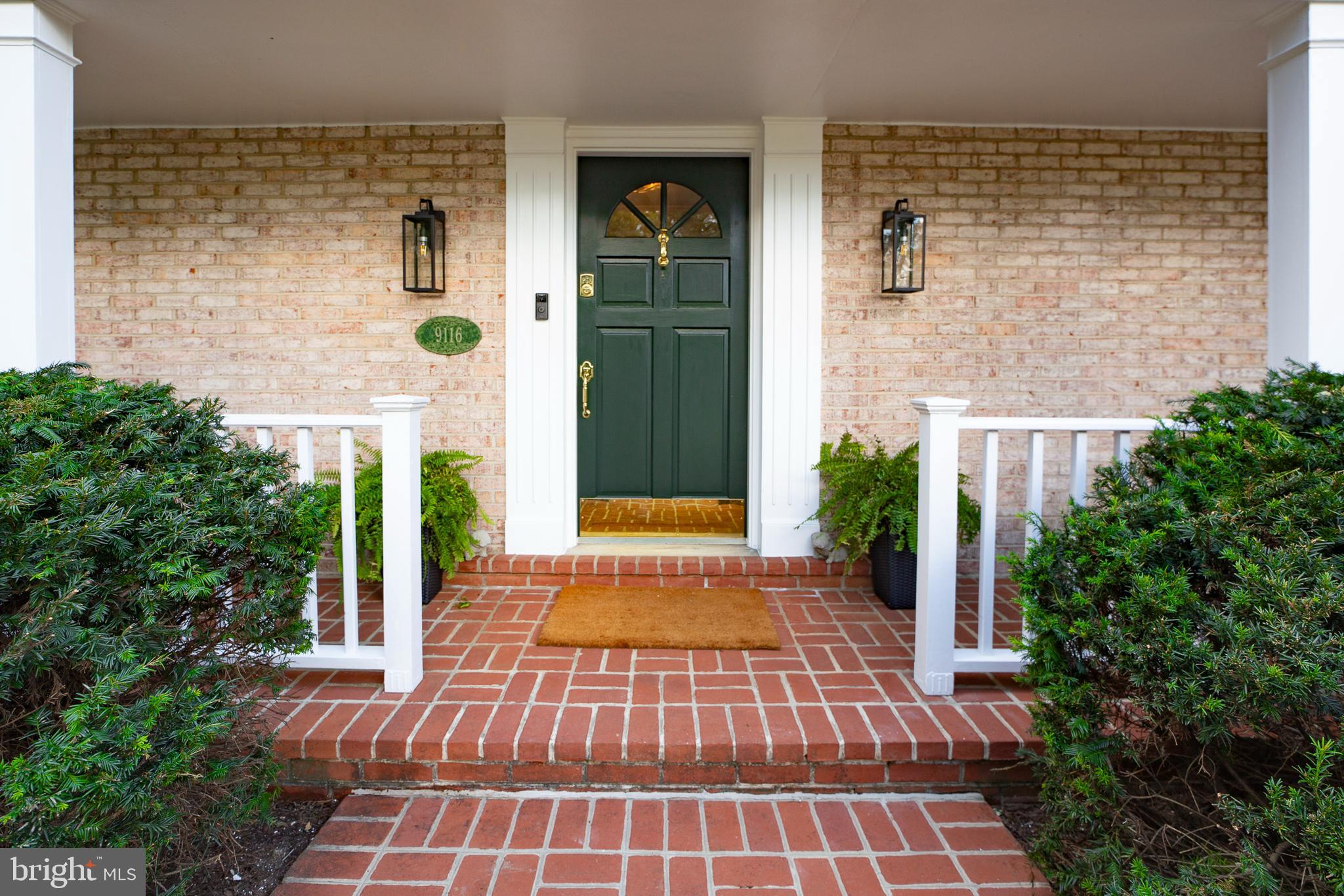 9116 Wooden Bridge Road Potomac, MD 20854 - Photo 3 of 22 a front view of a house with a yard
