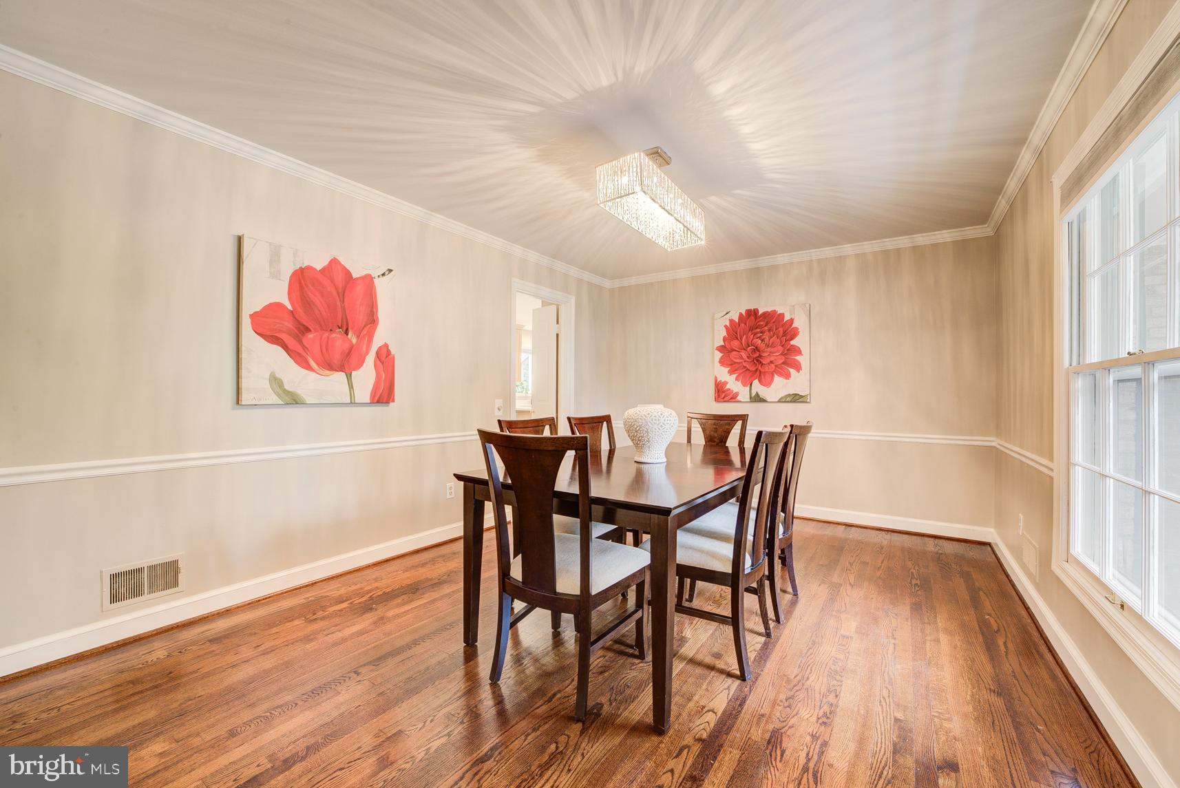 9116 Wooden Bridge Road Potomac, MD 20854 - Photo 5 of 22 a view of a dining room with furniture wooden floor and chandelier