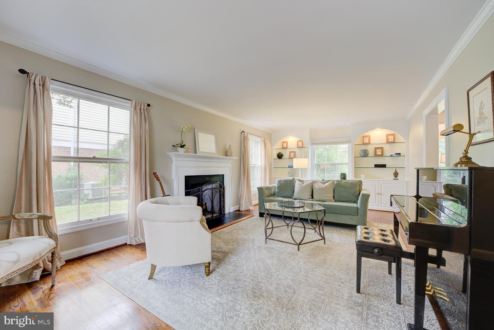 9116 Wooden Bridge Road Potomac, MD 20854 - Photo 6 of 22 a living room with furniture and a fireplace