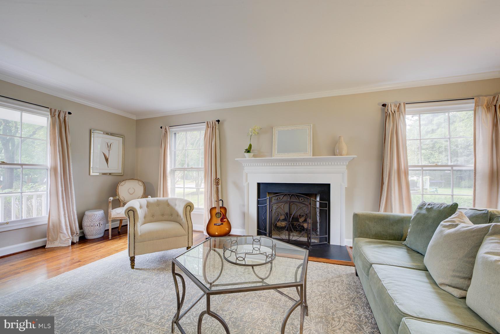 9116 Wooden Bridge Road Potomac, MD 20854 - Photo 7 of 22 a living room with furniture and a fireplace
