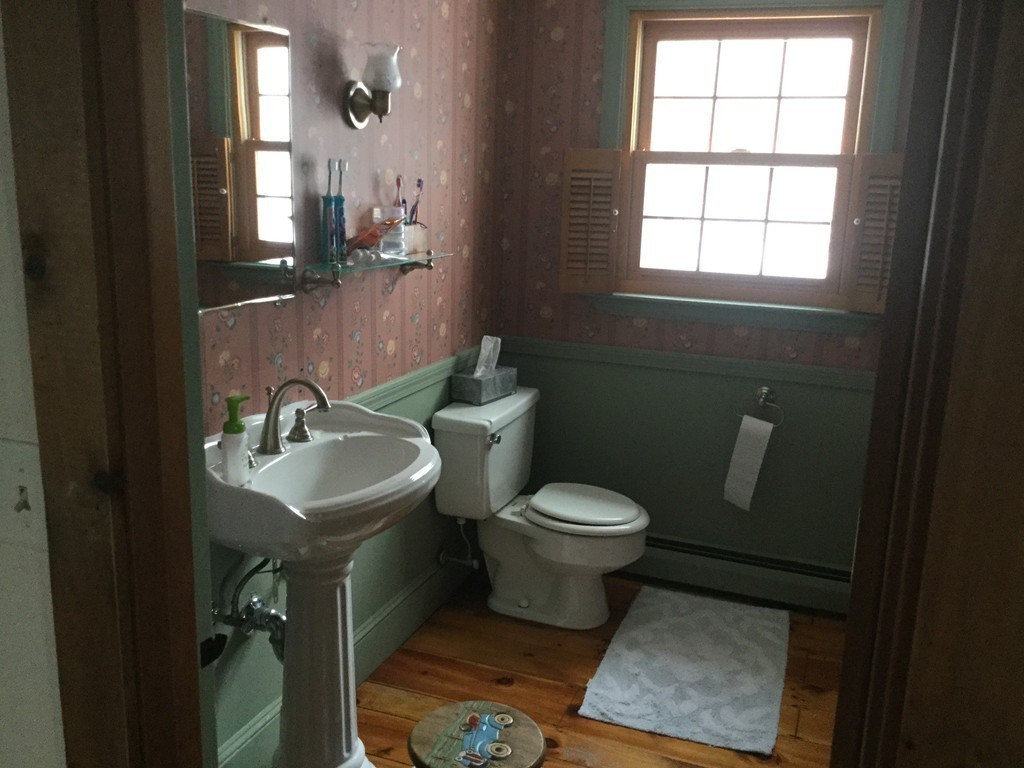 35 Downey Street Hopkinton, MA 01748 - Photo 11 of 28 a bathroom with a toilet sink and mirror