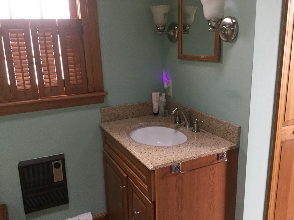 35 Downey Street Hopkinton, MA 01748 - Photo 20 of 28 a bathroom with a granite countertop sink and a mirror