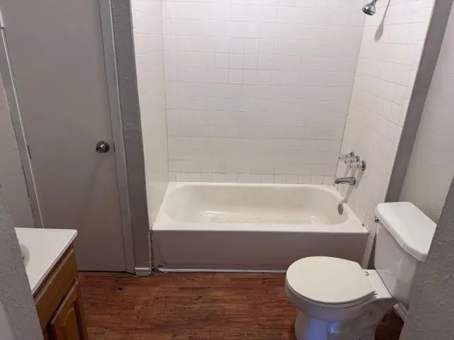 a bathroom with a toilet and a tub