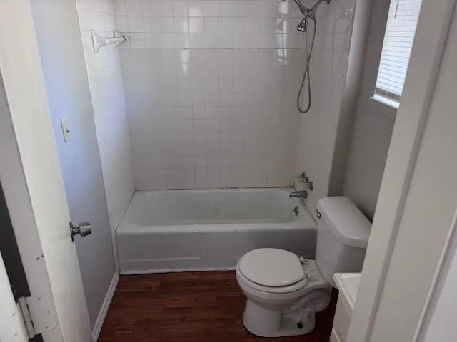 a bathroom with a toilet and a bath tub