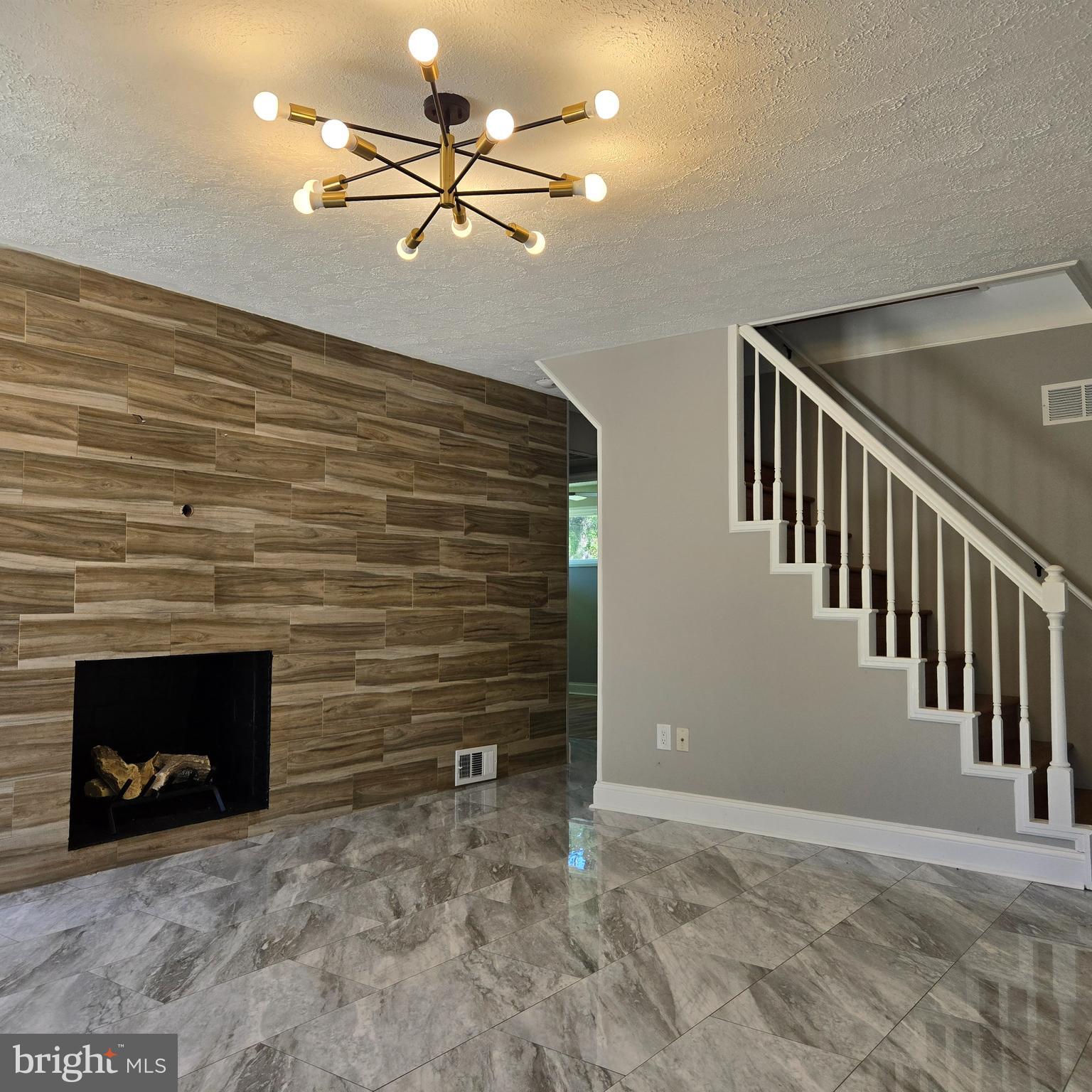 9711 Dilston Road Silver Spring, MD 20903 - Photo 12 of 44 a view of an empty room and chandelier fan