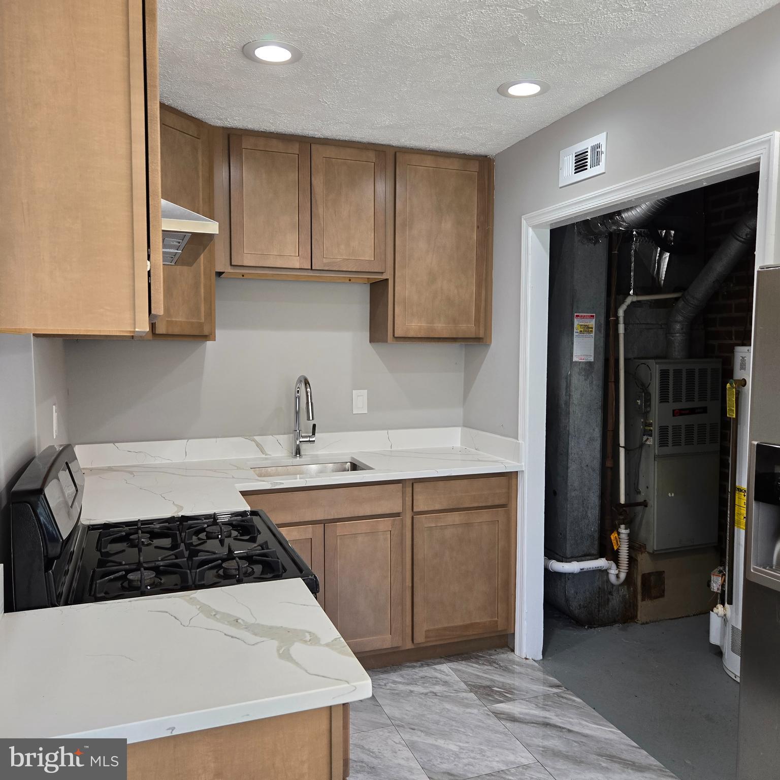 9711 Dilston Road Silver Spring, MD 20903 - Photo 16 of 44 a kitchen with a sink a stove and refrigerator
