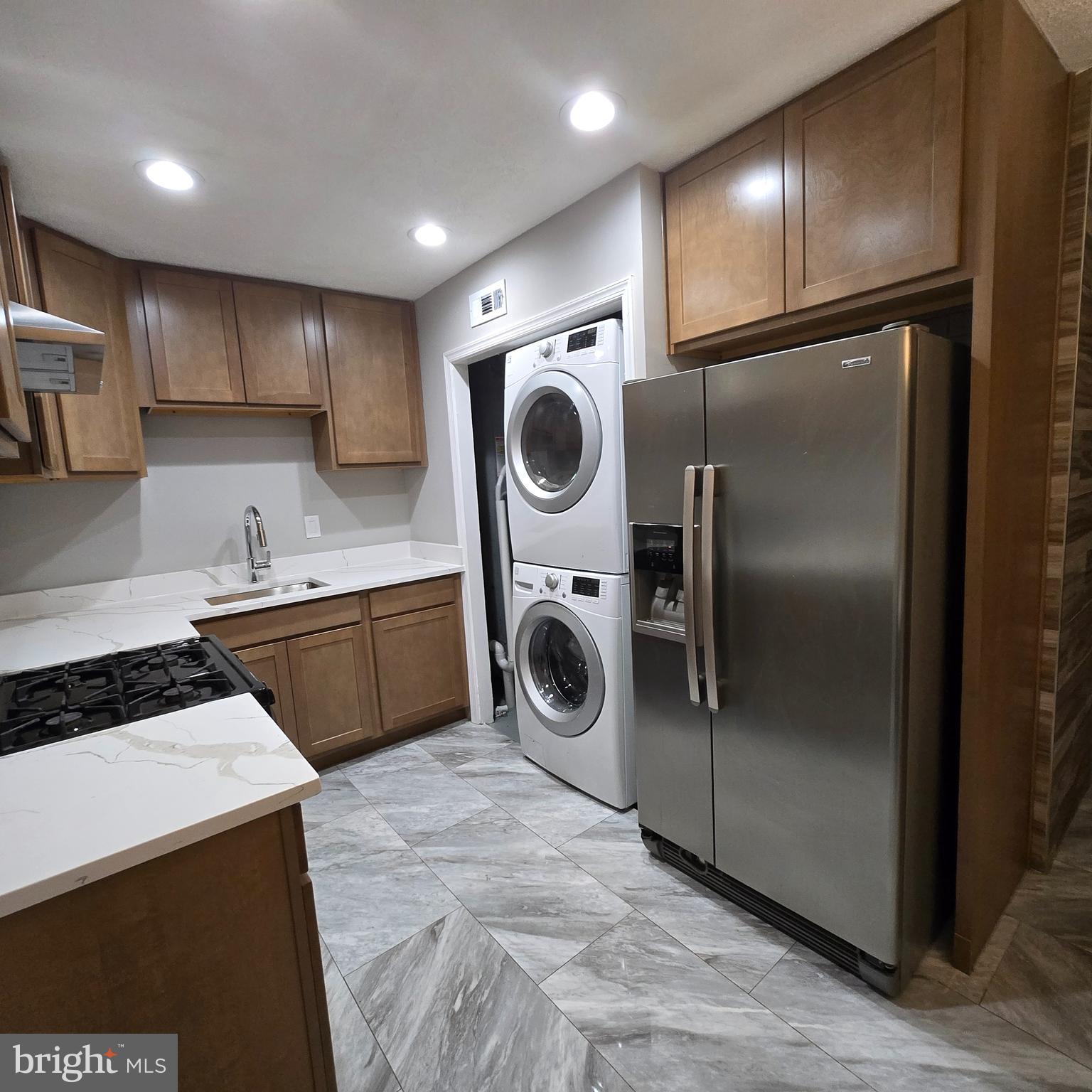 9711 Dilston Road Silver Spring, MD 20903 - Photo 20 of 44 a kitchen with a refrigerator and a sink