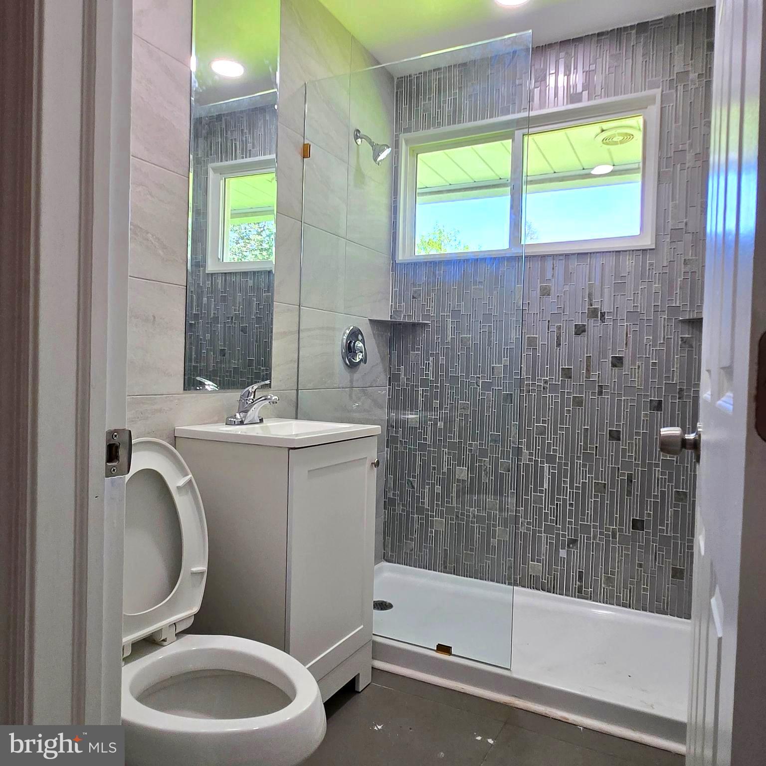 9711 Dilston Road Silver Spring, MD 20903 - Photo 28 of 44 a bathroom with a sink a toilet and a bathtub