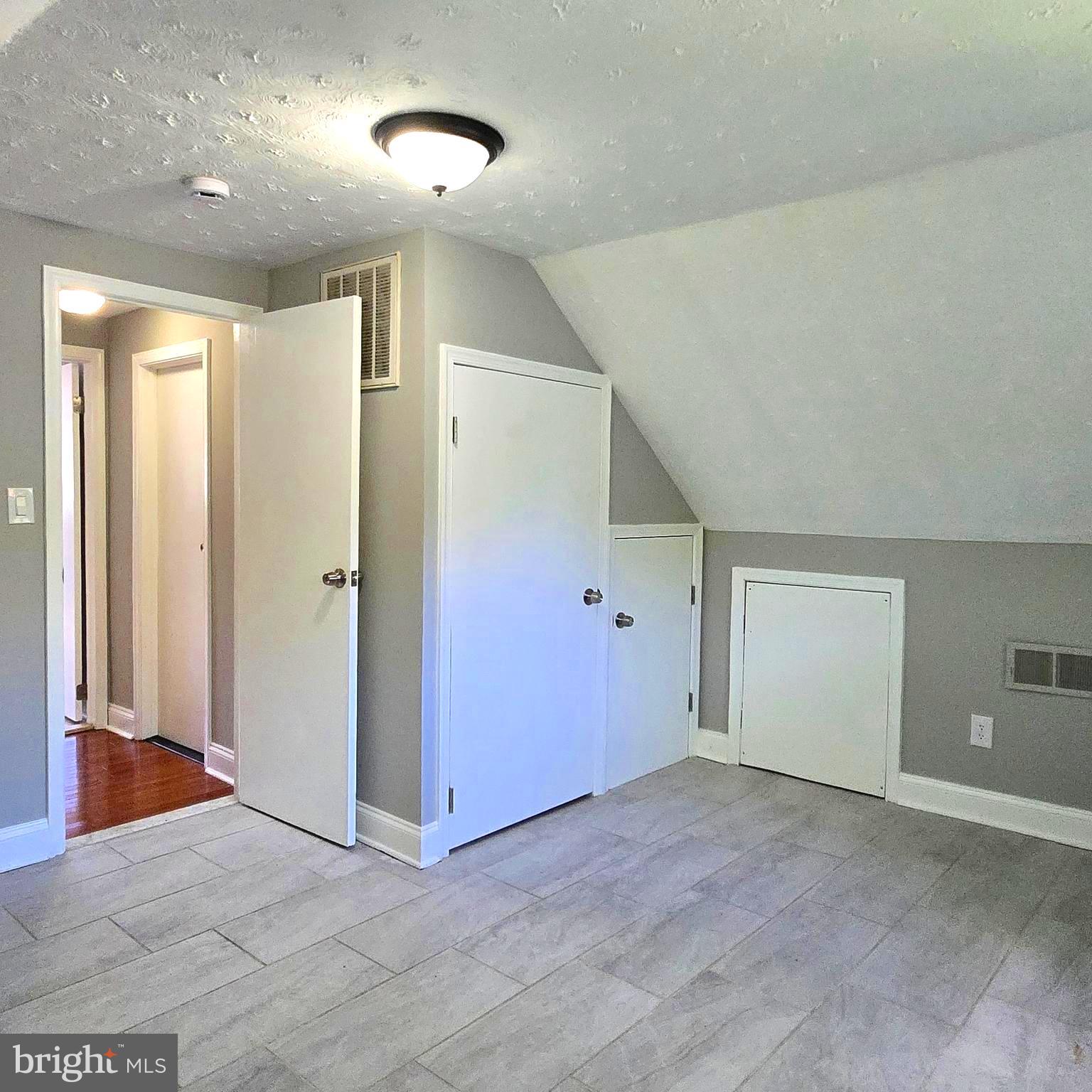 9711 Dilston Road Silver Spring, MD 20903 - Photo 43 of 44 an empty room with closet and windows