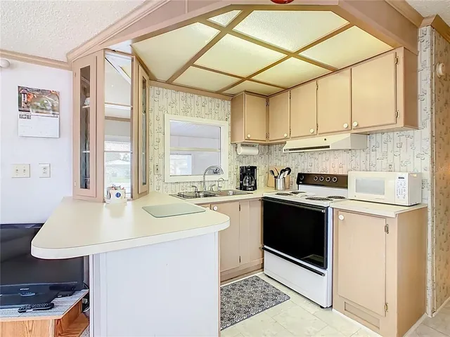 a kitchen with a sink cabinets and window