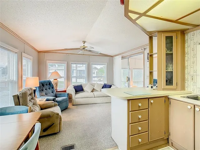 a living room with furniture and large windows