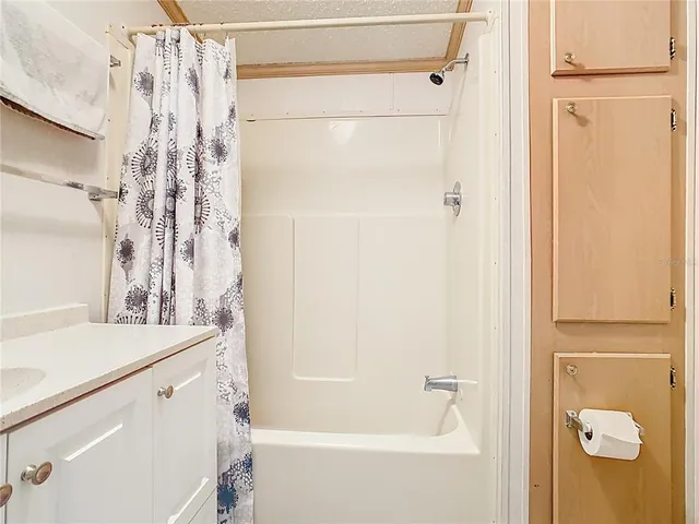 a bathroom with a sink and a shower curtain