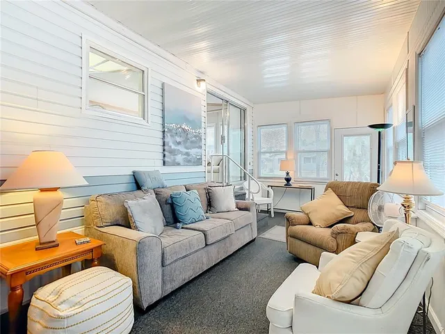 a living room with furniture and a lamp