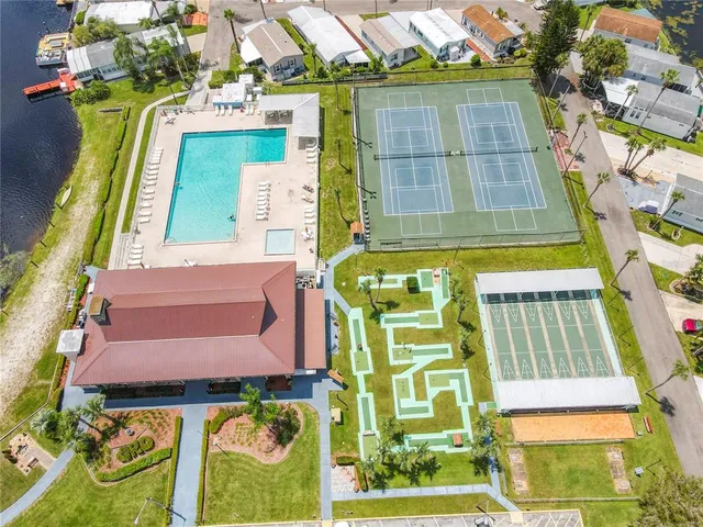 an aerial view of a house with a yard and lake view