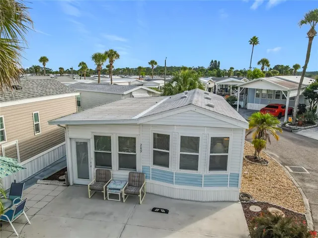 a view of a patio with table and chairs and potted plants