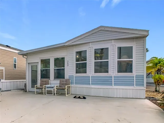 a backyard of a house with outdoor seating