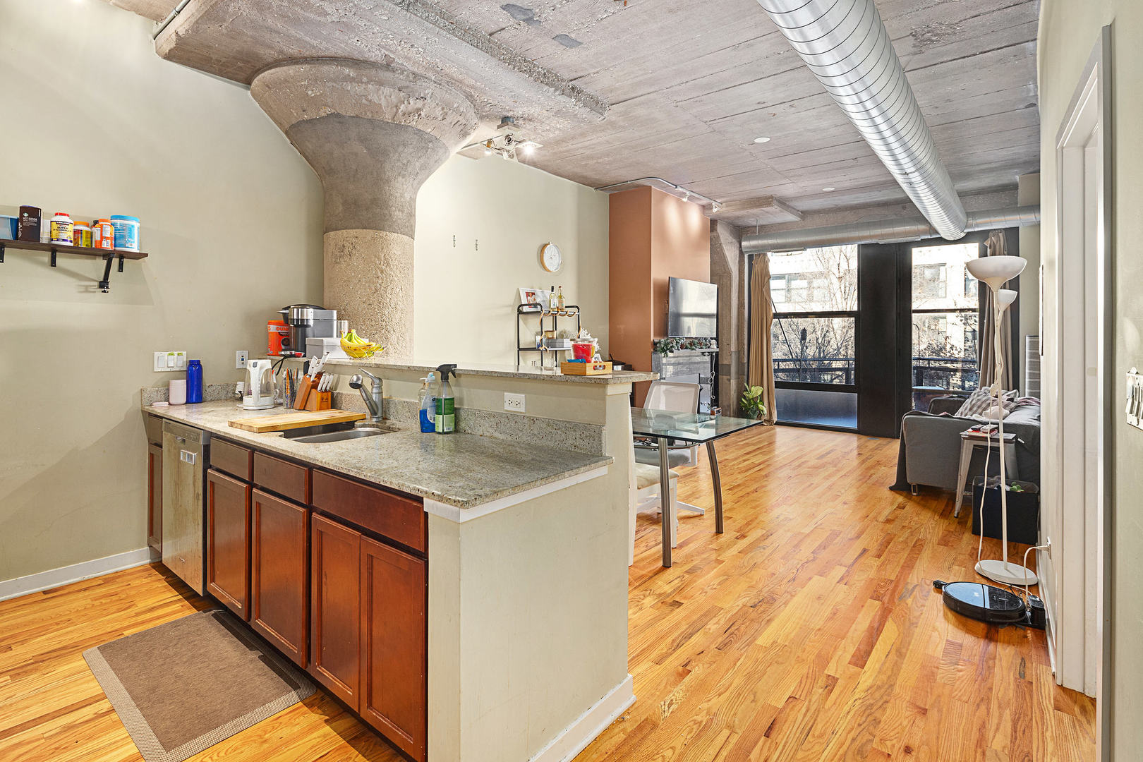 1111 West 15th Street, Unit 235 Chicago, IL 60608 - Photo 12 of 21 a kitchen with stainless steel appliances granite countertop a sink and cabinets