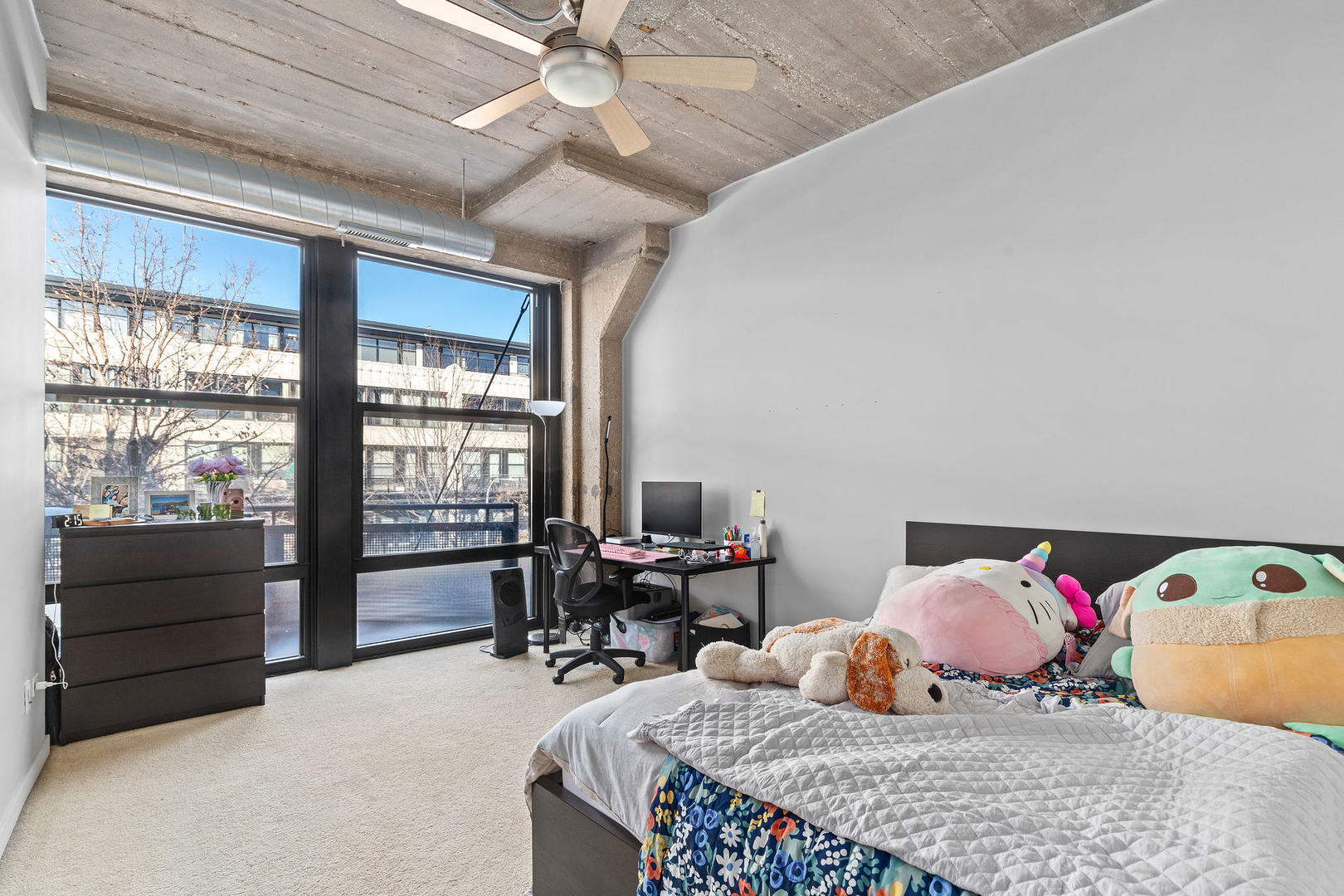 1111 West 15th Street, Unit 235 Chicago, IL 60608 - Photo 13 of 21 a bedroom with a bed and wooden floor