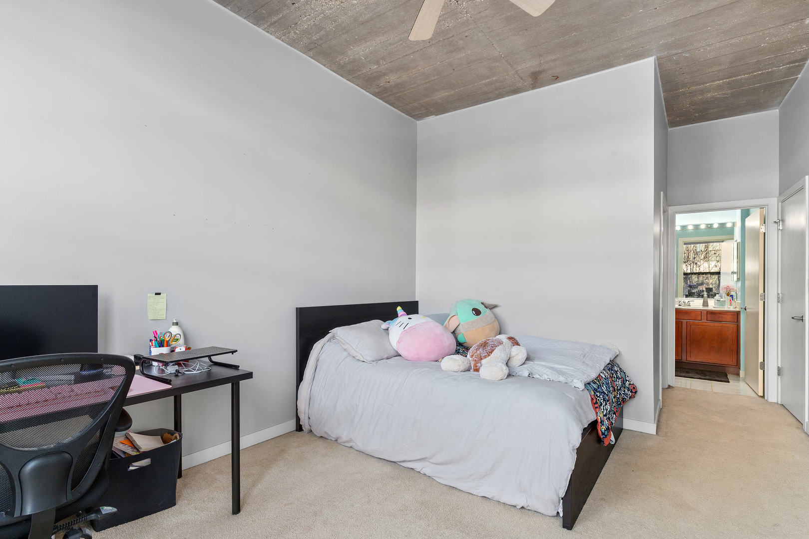 1111 West 15th Street, Unit 235 Chicago, IL 60608 - Photo 14 of 21 a bedroom with a bed and a flat screen tv