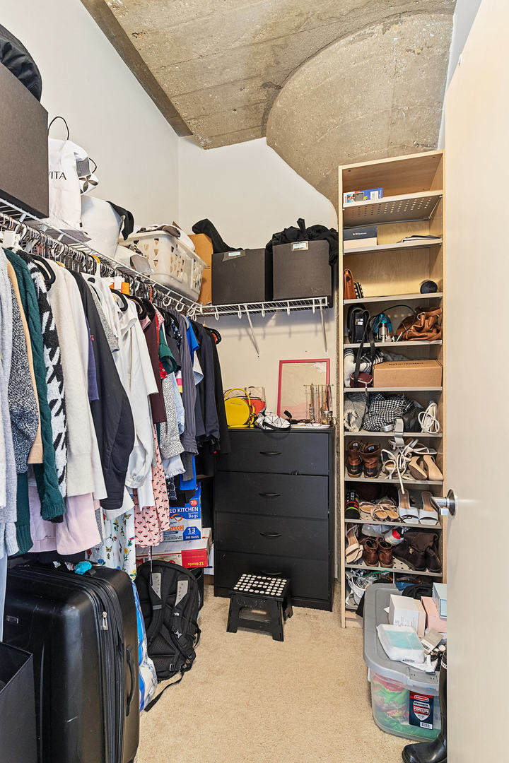 1111 West 15th Street, Unit 235 Chicago, IL 60608 - Photo 15 of 21 a view of walk in closet with clothes and shoes