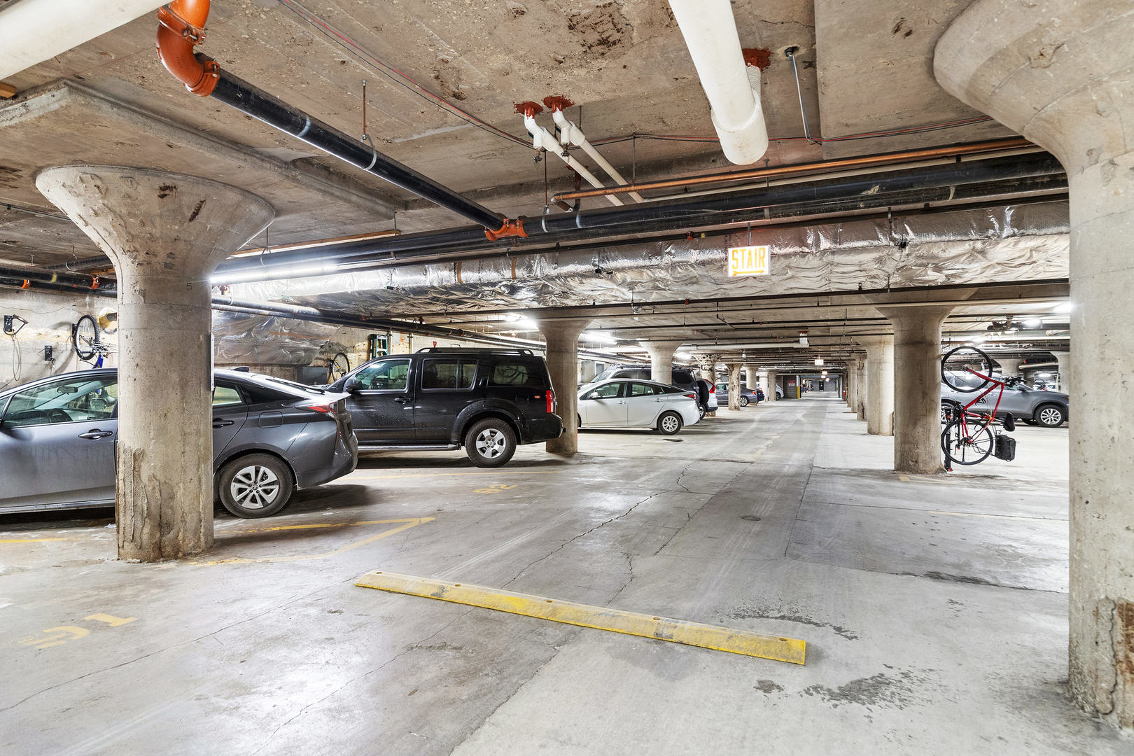 1111 West 15th Street, Unit 235 Chicago, IL 60608 - Photo 20 of 21 a view of parking garage with cars