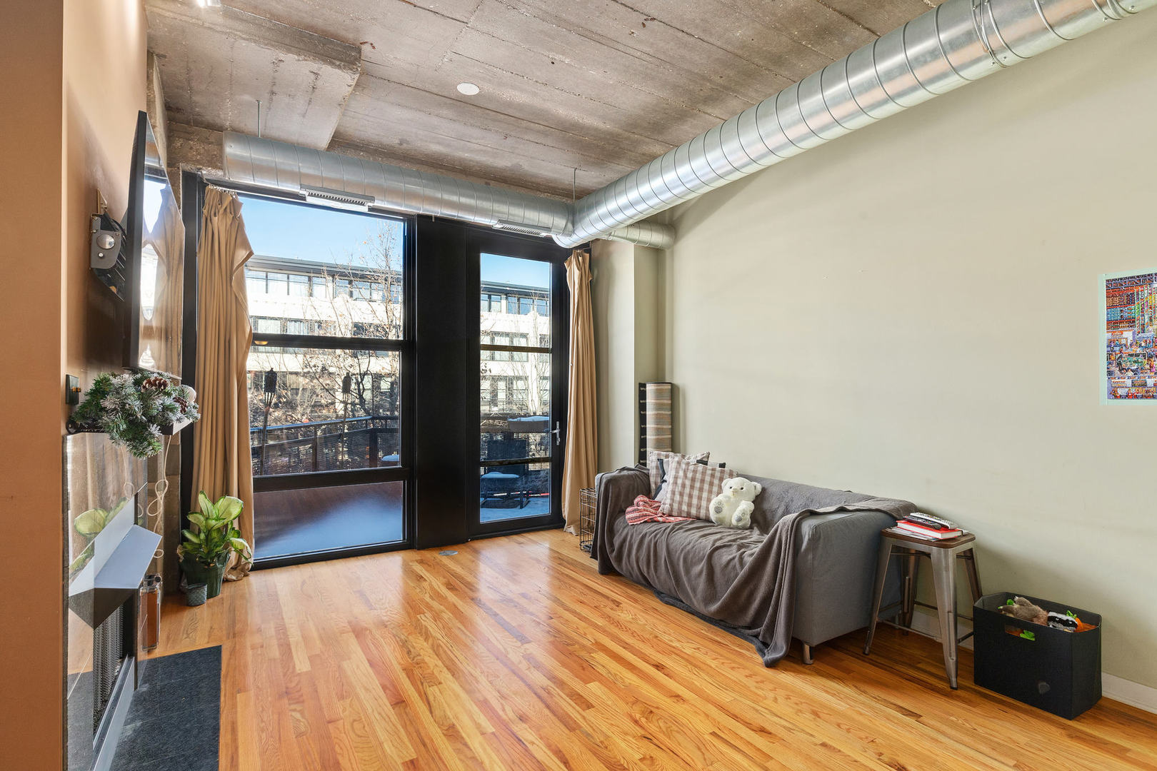1111 West 15th Street, Unit 235 Chicago, IL 60608 - Photo 7 of 21 a bedroom with a bed and a large window