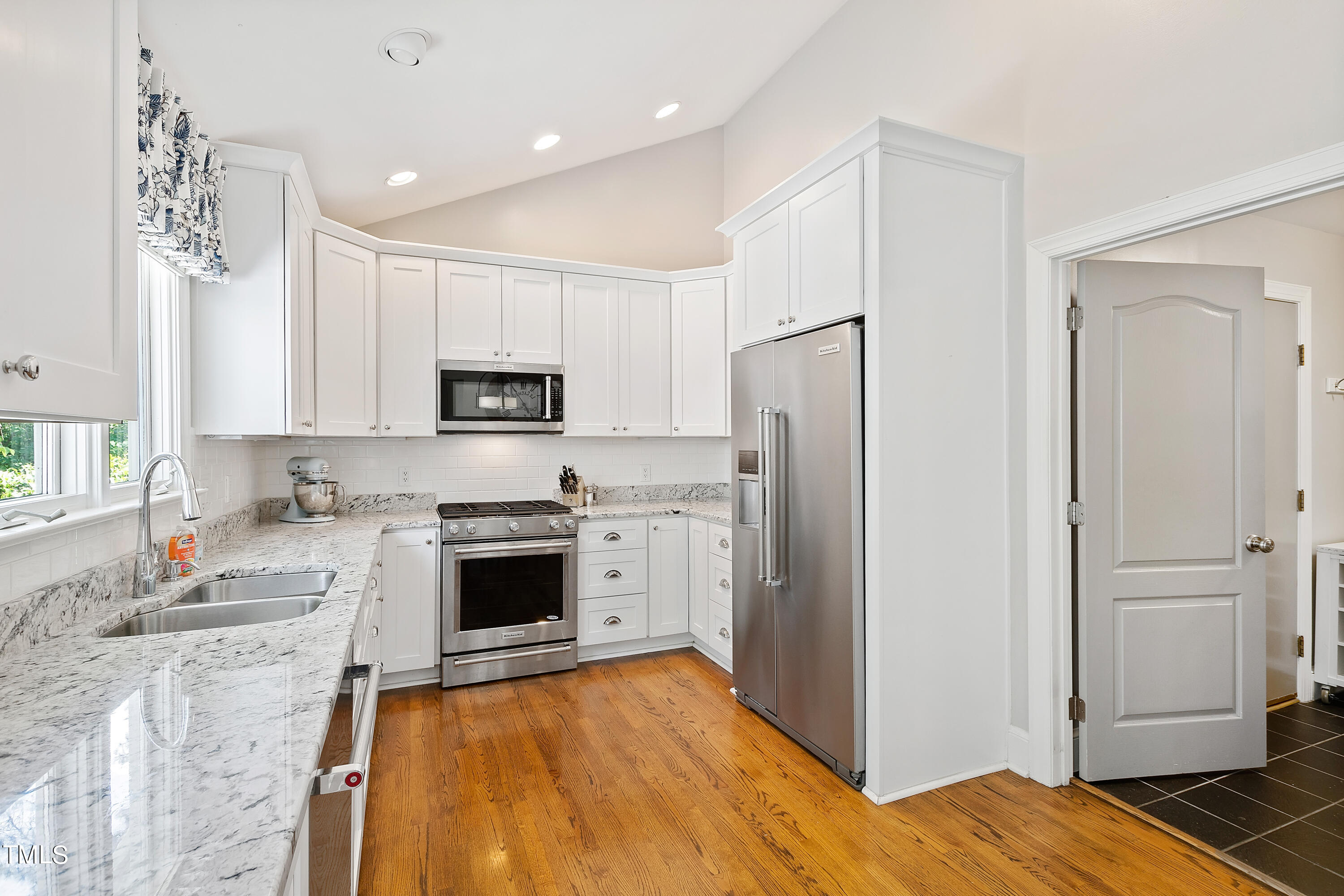 1605 Quaker Ridge Point Raleigh, NC 27615 - Photo 11 of 54 a kitchen with stainless steel appliances granite countertop a refrigerator stove and sink
