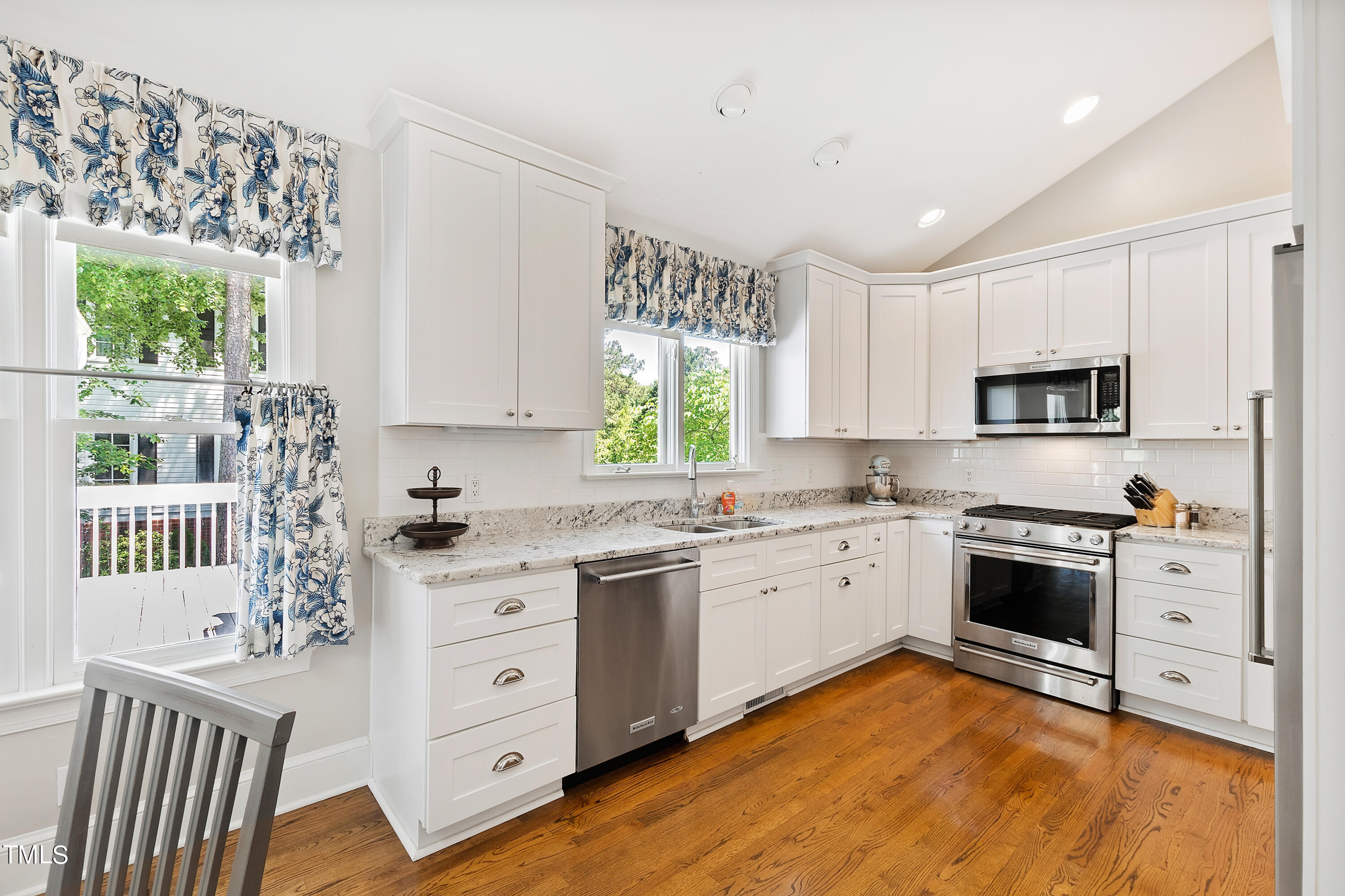 1605 Quaker Ridge Point Raleigh, NC 27615 - Photo 12 of 54 a kitchen with stainless steel appliances granite countertop a stove and a sink