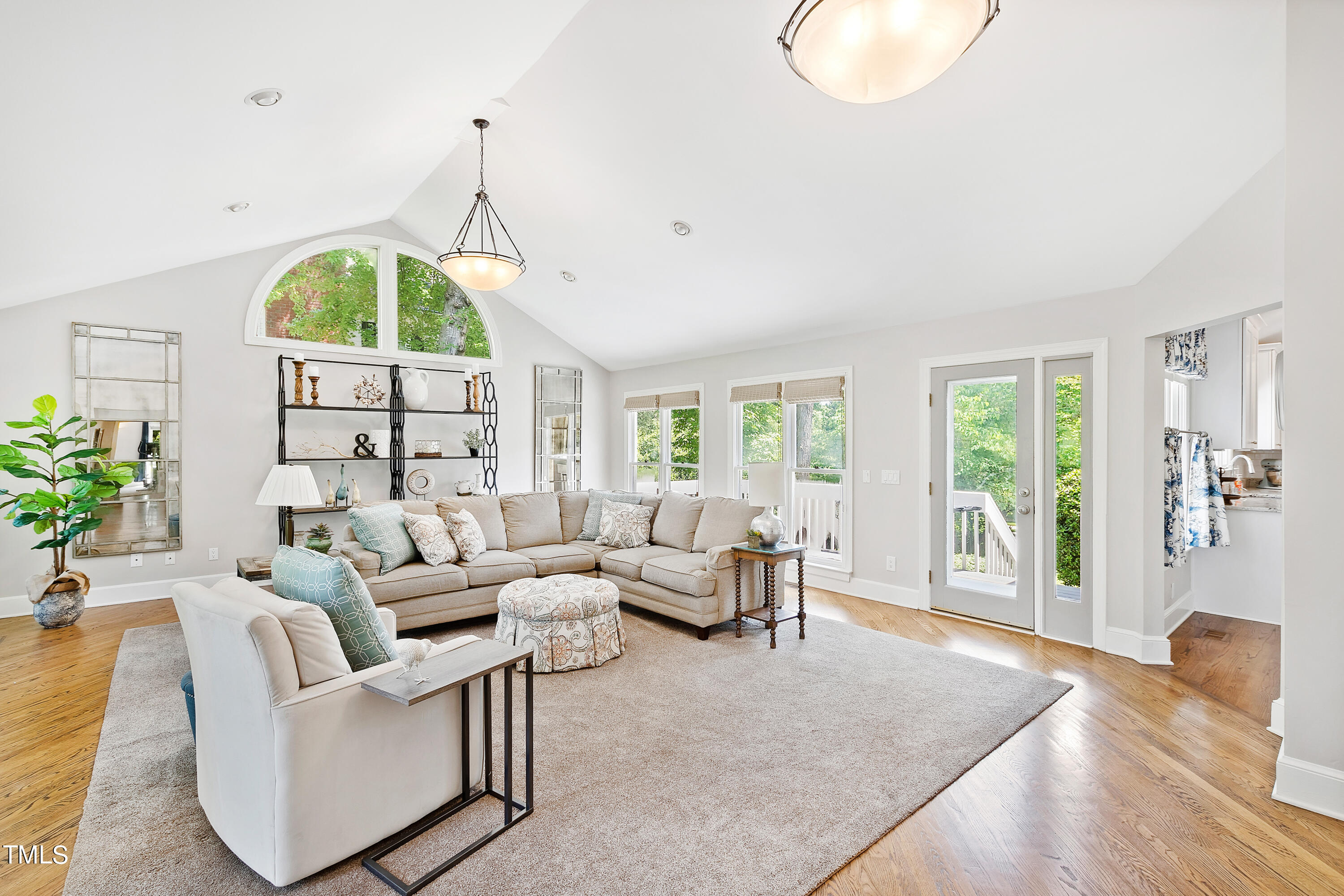 1605 Quaker Ridge Point Raleigh, NC 27615 - Photo 20 of 54 a living room with furniture a fireplace and a chandelier
