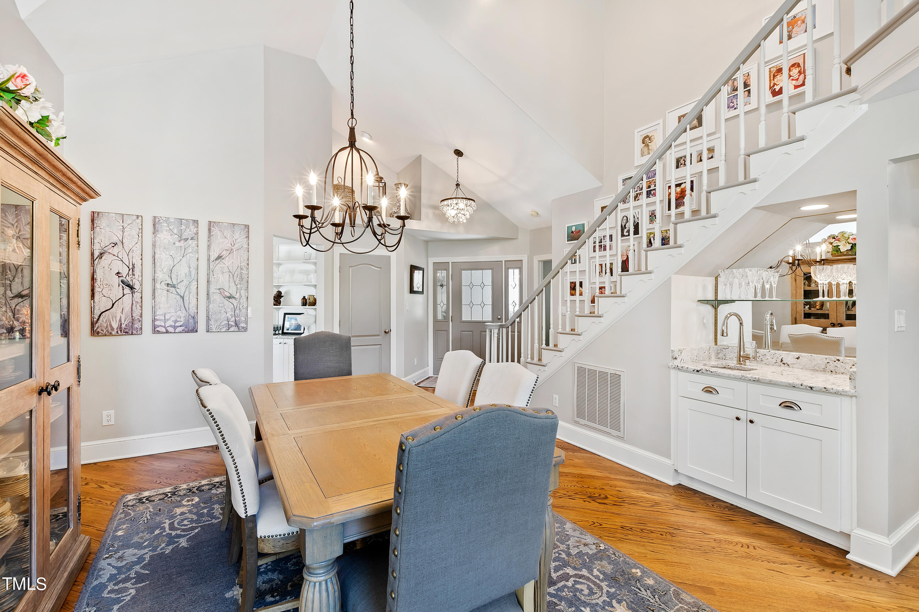 1605 Quaker Ridge Point Raleigh, NC 27615 - Photo 8 of 54 a view of a dining room with furniture and a chandelier