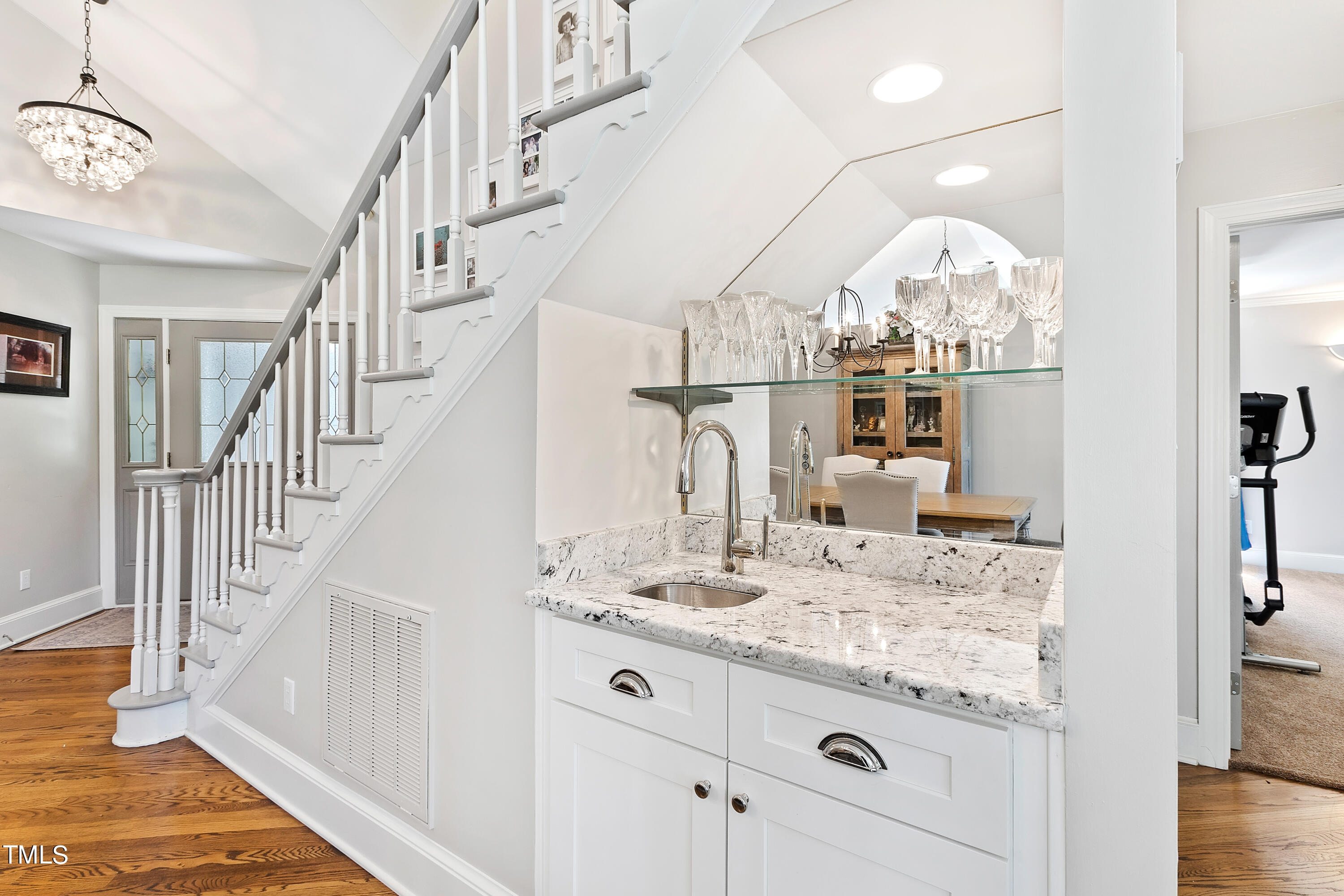 1605 Quaker Ridge Point Raleigh, NC 27615 - Photo 9 of 54 a room with lots of white furniture and chandelier