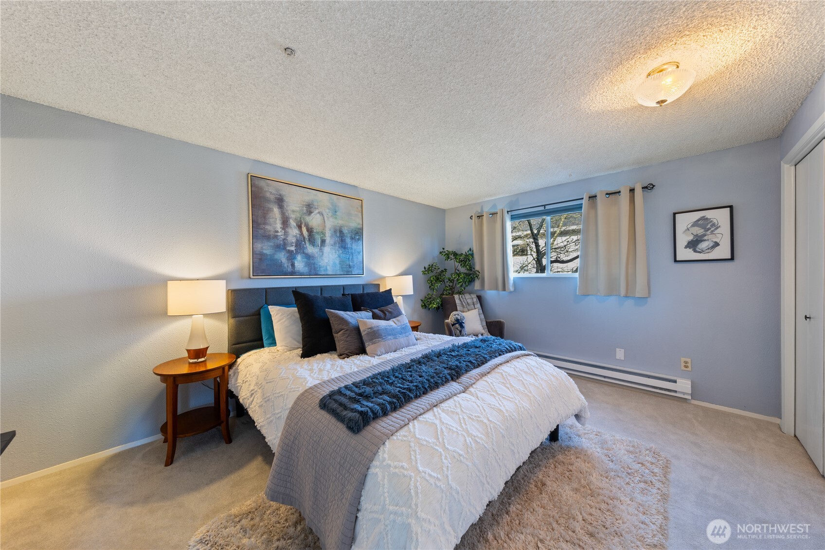 242 4th Avenue South, Unit 2 Edmonds, WA 98020 - Photo 15 of 34 a bedroom with a bed and a painting on the wall
