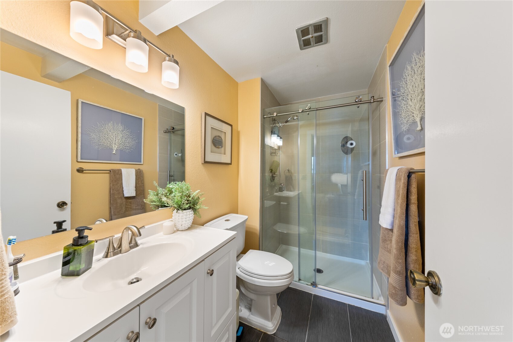 242 4th Avenue South, Unit 2 Edmonds, WA 98020 - Photo 19 of 34 a bathroom with a shower sink vanity mirror and toilet