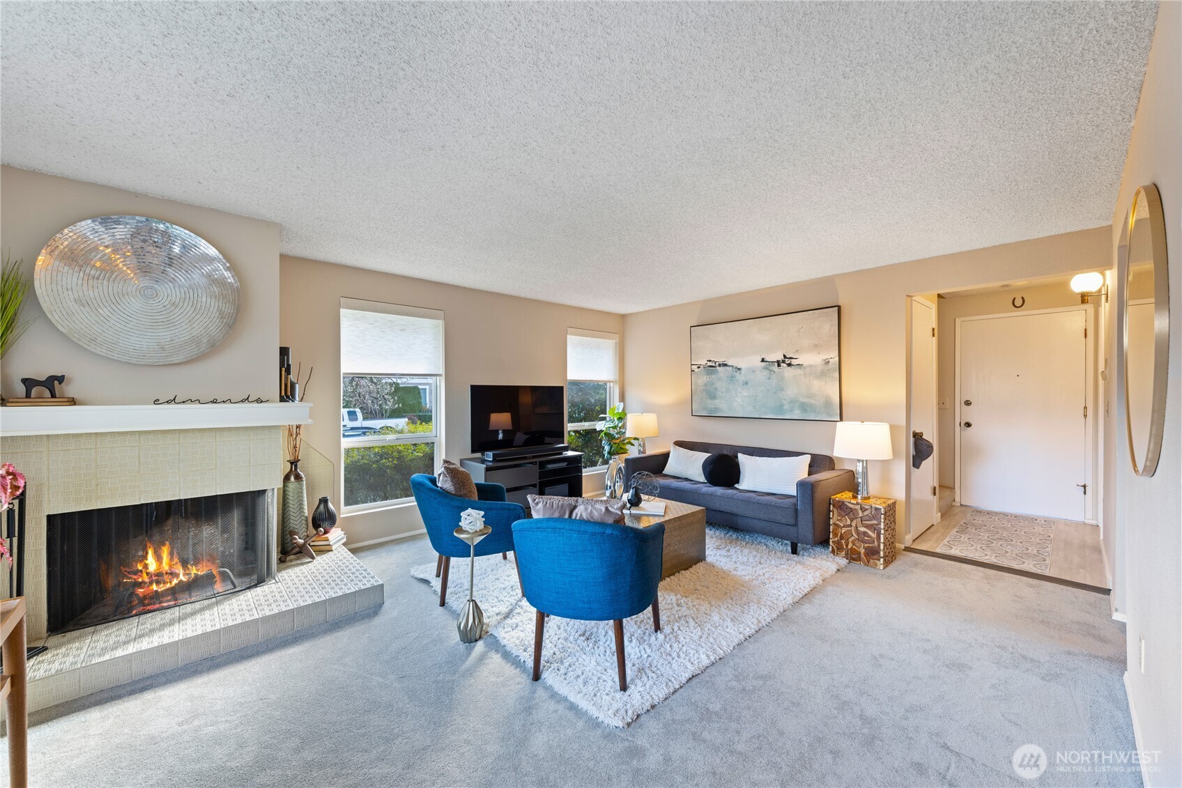 242 4th Avenue South, Unit 2 Edmonds, WA 98020 - Photo 5 of 34 a living room with furniture a fireplace and a flat screen tv