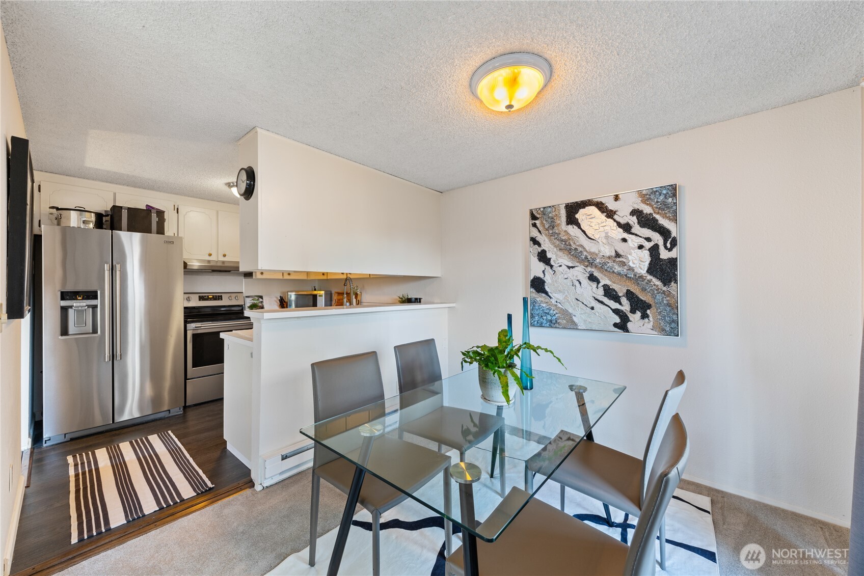 242 4th Avenue South, Unit 2 Edmonds, WA 98020 - Photo 6 of 34 a kitchen with stainless steel appliances a refrigerator and a stove top oven