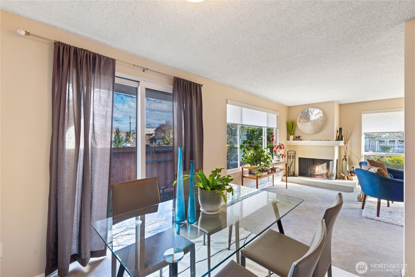 242 4th Avenue South, Unit 2 Edmonds, WA 98020 - Photo 8 of 34 a living room with furniture a fireplace and a floor to ceiling window
