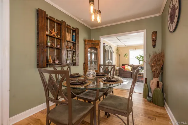 a view of a dining room with furniture and a window