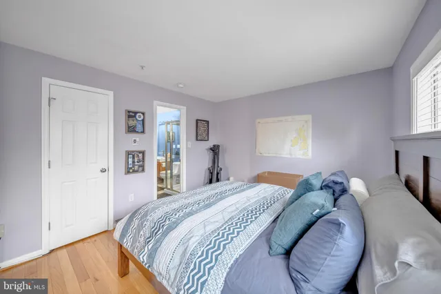 a living room with furniture a flat screen tv and a dining table