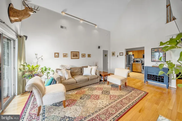 a living room with a couch and wooden floor