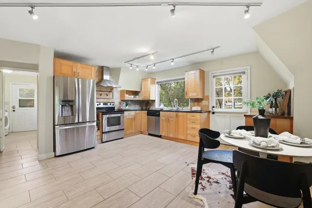 a large open kitchen with a table and chairs
