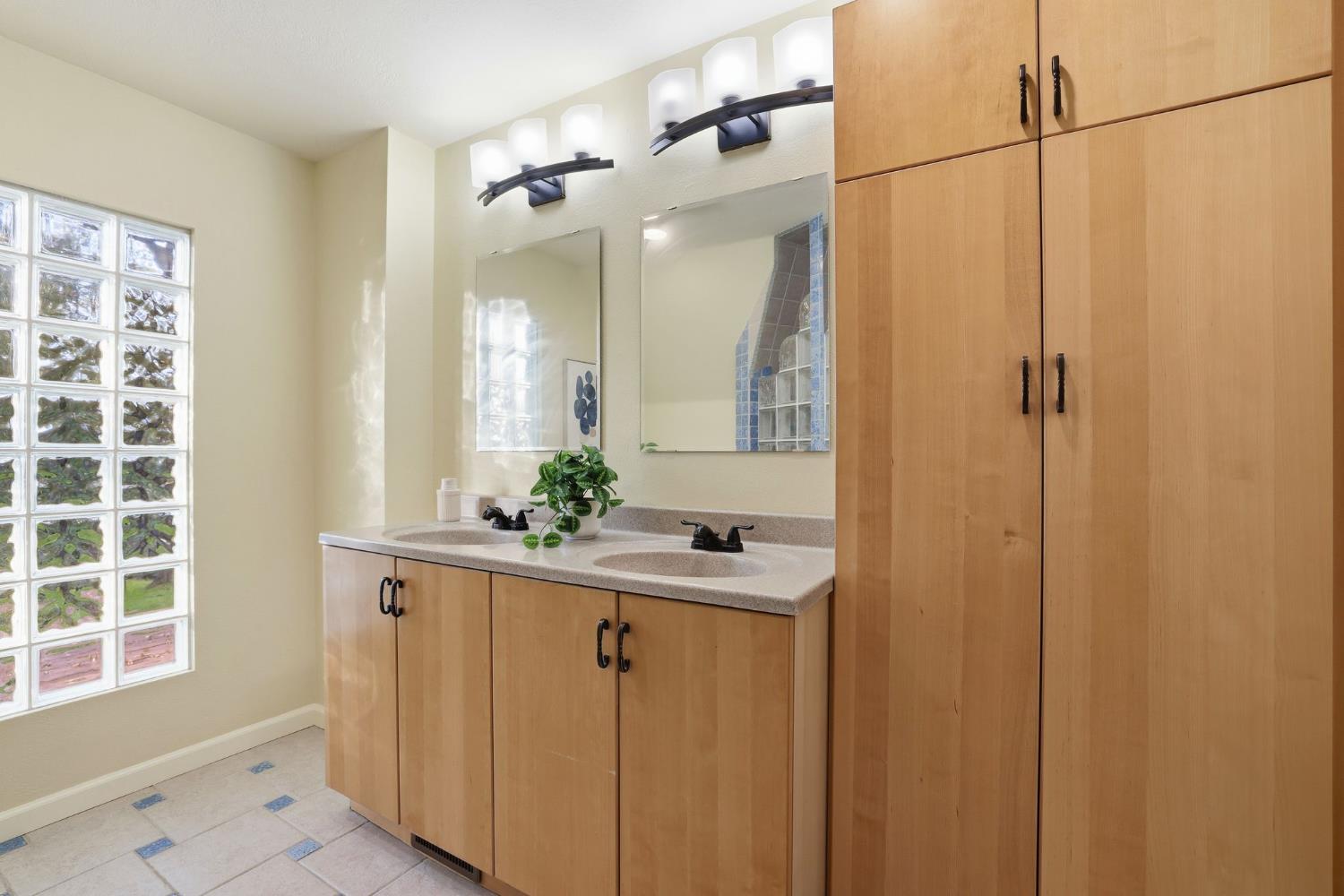 7890 Boren Lane Granite Bay, CA 95746 - Photo 29 of 96 a bathroom with a sink a mirror and a shower